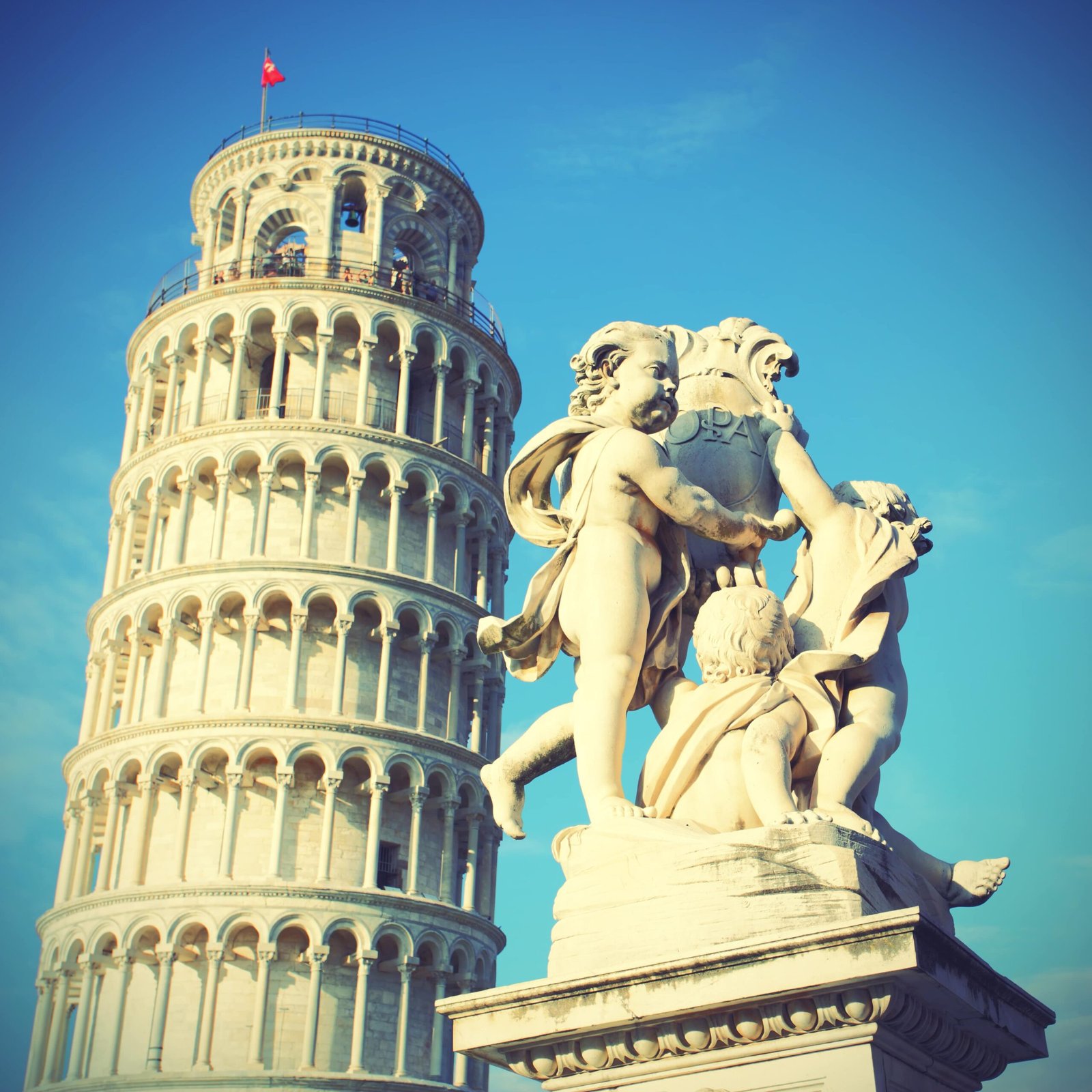 leaning-tower-pisa-la-fontana-dei-putti-statue-italy-toned-image-min